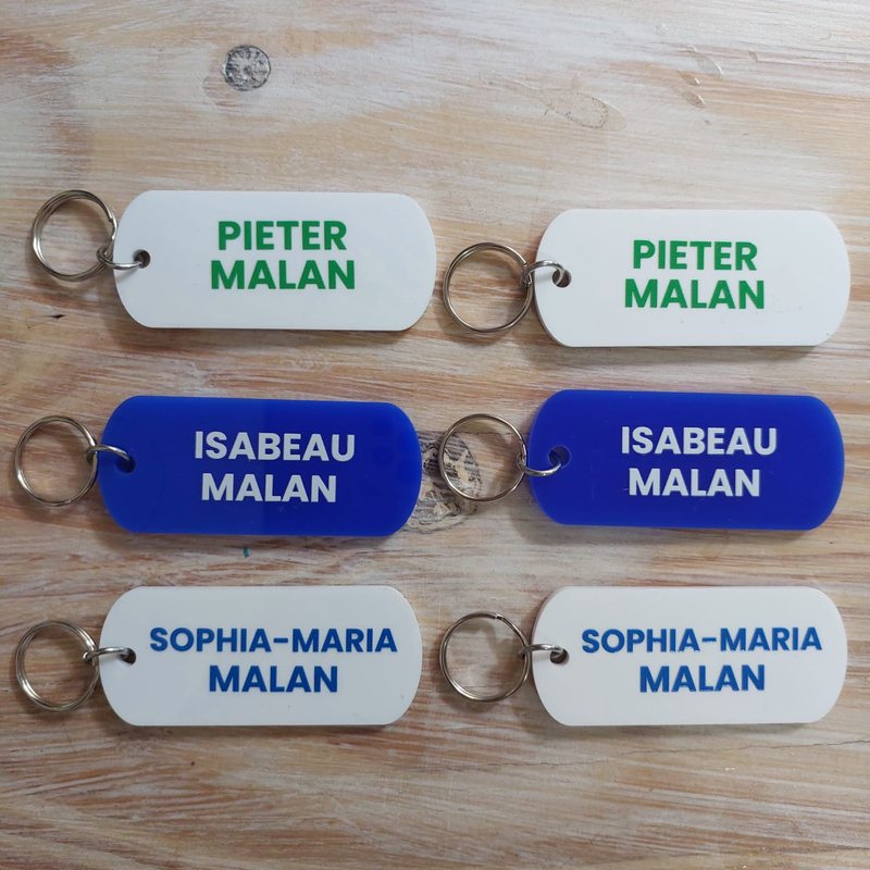 White and blue Perspex bag tags for three children
